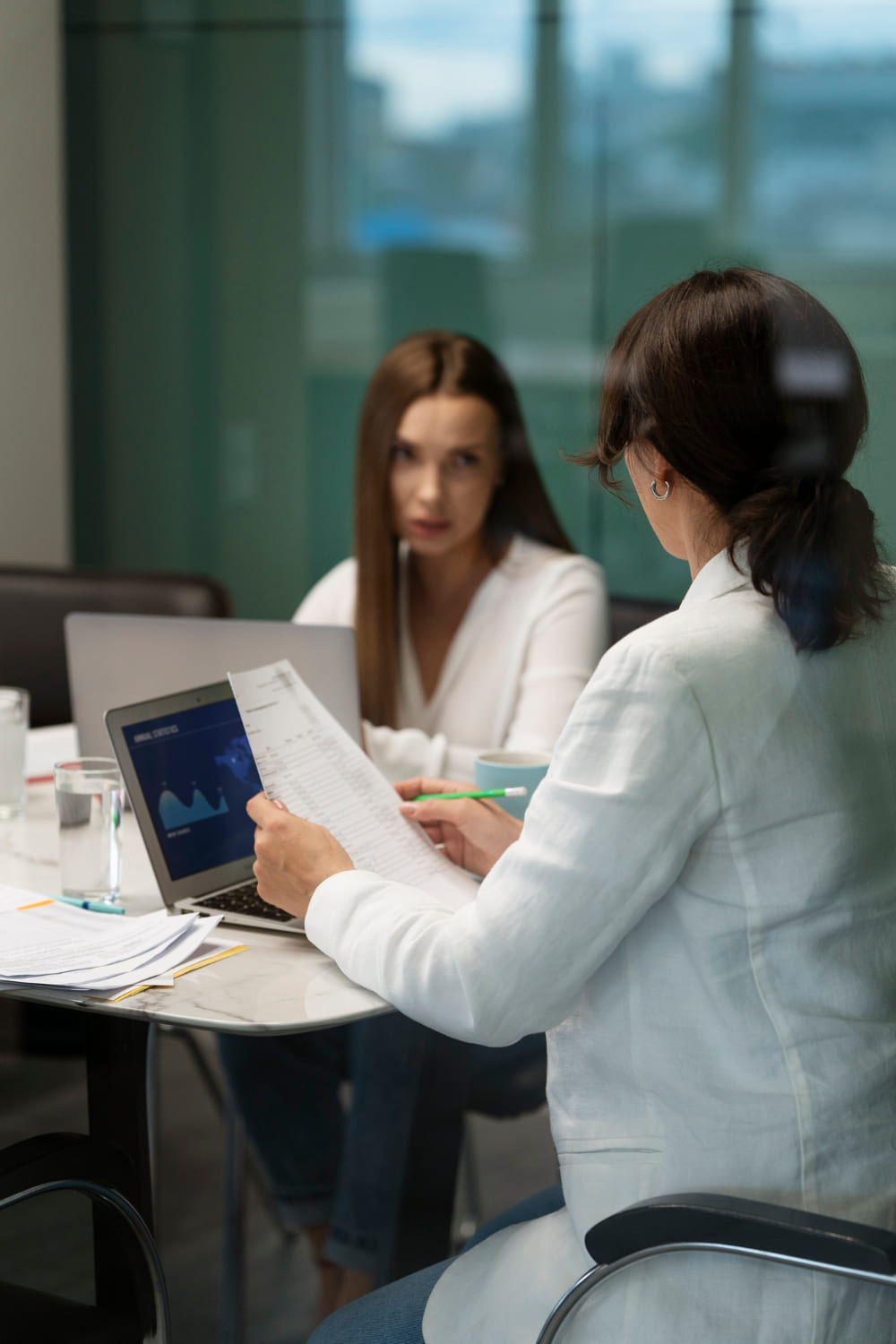 Healthcare provider in white coat reviewing a document with a patient, representing personalized psychiatric care