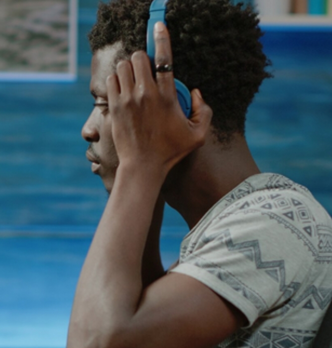 Man wearing headphones during a telehealth session, representing accessible online psychiatric care at Abroi Psychiatry