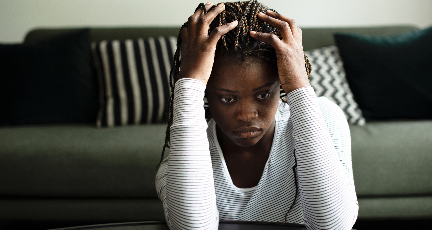 Woman gripping her hair with an intense expression, representing intrusive thoughts and distress associated with OCD