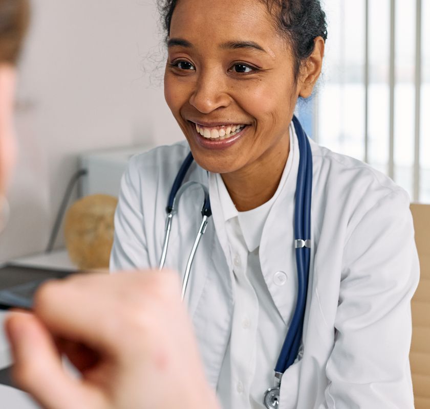 Smiling psychiatric provider discussing medication management with a patient
