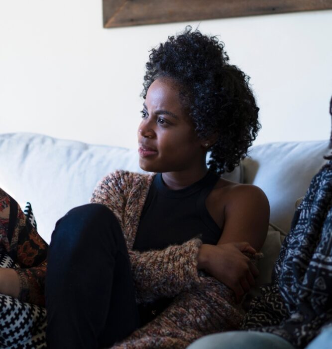 Three women sitting together in conversation, representing community support for women's mental health concerns